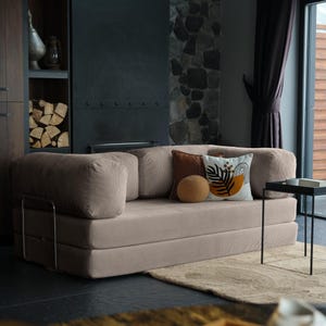 Modular teddy floor sofa bed arranged in a sectional layout, transforming easily into a guest-ready sleep solution.