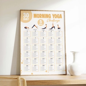 Printable morning yoga challenge in a wood frame on a shelf.