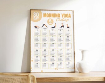 Può includere: Un poster incorniciato con una sfida di yoga mattutino di 30 giorni. Il poster presenta illustrazioni di posizioni yoga e un programma giornaliero. Il testo "Morning Yoga Challenge" è visualizzato in arancione chiaro.