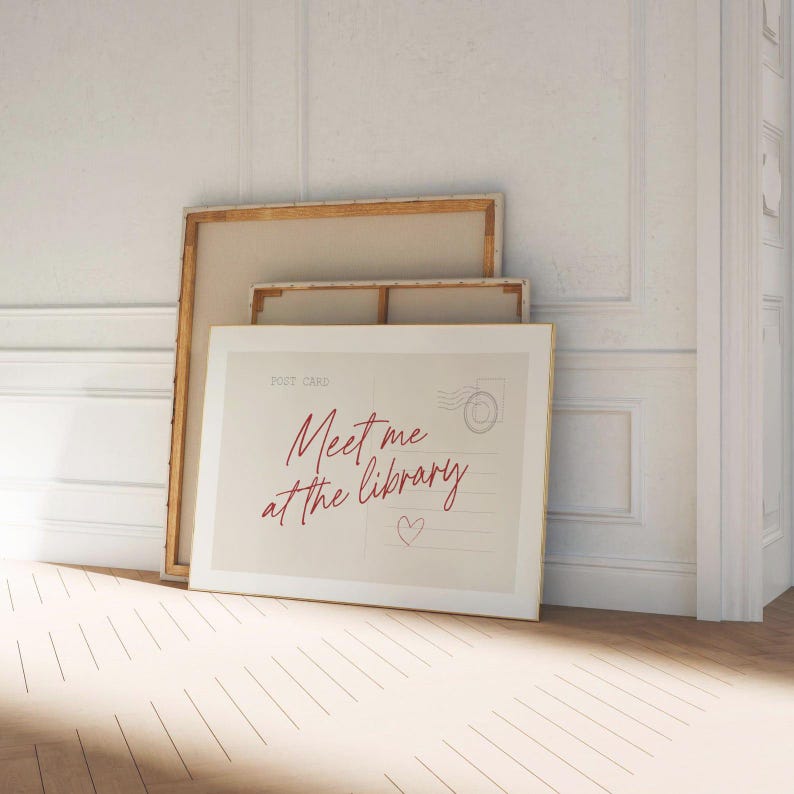 Framed "Meet me at the library" artwork.