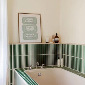 A retro shower karaoke ticket-style bathroom artwork, styled above a bathtub.