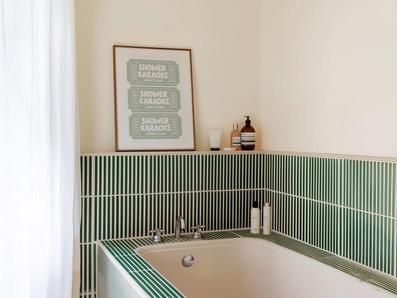 A retro shower karaoke ticket-style bathroom artwork, styled above a bathtub.