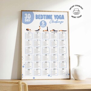 Framed printable 30 Day Bedtime Yoga Challenge poster displayed on a wooden shelf, featuring a calming night time yoga plan with 5-minute daily stretches for better sleep hygiene. Ideal for beginners, seniors, or those over 50, this easy yoga routine uses bodyweight exercises and includes illustrated poses like Child’s Pose and Corpse Pose. Perfect for improving sleep, establishing a consistent night time routine, and supporting wellness at home.