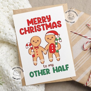 May include: A Christmas card with the text "MERRY CHRISTMAS to my OTHER HALF" in red and green. The card features two gingerbread people holding candy canes. A gift wrapped in brown paper with red and white twine is in the background.