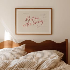 Framed "Meet me at the library" artwork.