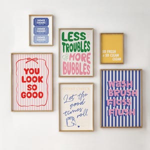 May include: A gallery wall set of six framed prints with various designs. Text includes Shower Karaoke, Less Troubles More Bubbles, So Fresh & So Clean Clean, You Look So Good, Let The Good Times Roll, and Wash Brush Floss Flush.