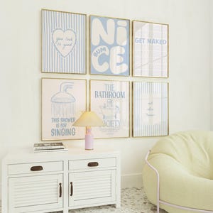 May include: A gallery wall set of six framed prints with light blue and white color schemes. The prints feature text including "you look so good," "NICE BUM," "GET NAKED," "THIS SHOWER IS FOR SINGING," and "THE BATHROOM SOCIETY" alongside various bathroom-themed illustrations.