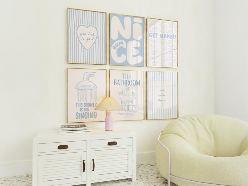 May include: A gallery wall set of six framed prints with light blue and white color schemes. The prints feature text including "you look so good," "NICE BUM," "GET NAKED," "THIS SHOWER IS FOR SINGING," and "THE BATHROOM SOCIETY" alongside various bathroom-themed illustrations.