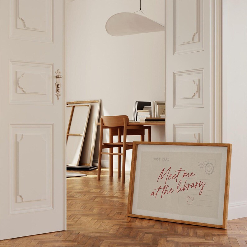 Framed "Meet me at the library" artwork.