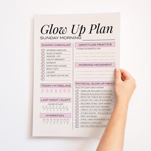 Hand holding printable Glow Up Plan.