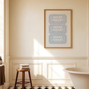 Printable wall art says "Shower Karaoke" , displayed above a bathtub.