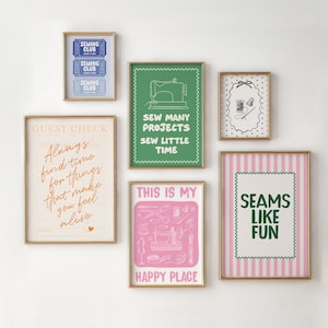 May include: A gallery wall arrangement of six framed art prints featuring sewing-themed illustrations and typography. The prints include text such as Sewing Club, Sew Many Projects Sew Little Time, Always find time for things that make you feel alive, This is my happy place, and Seams Like Fun, displayed in gold frames.