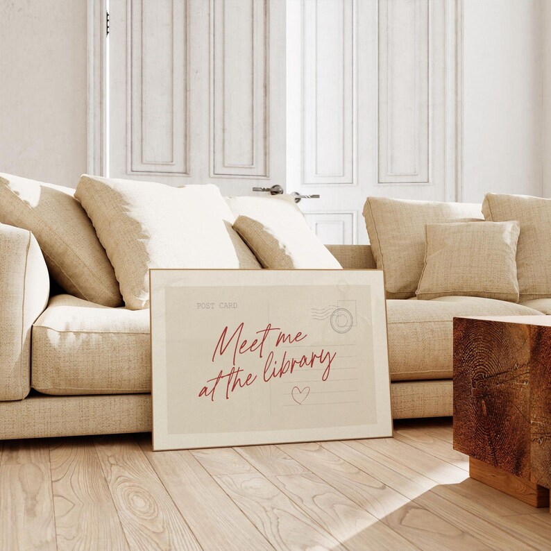 Framed "Meet me at the library" artwork.