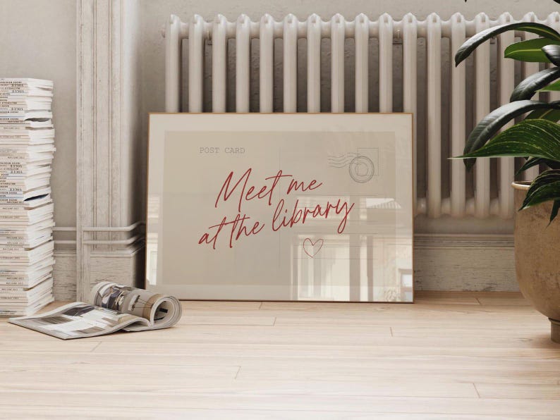 Framed "Meet me at the library" artwork.