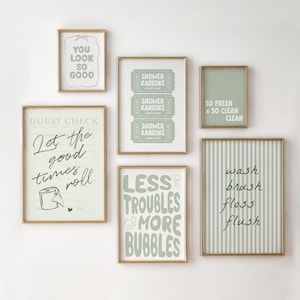 May include: A collection of framed wall art with gold frames. The art features various text-based designs in shades of green and white, including phrases like "You Look So Good" and "Let the good times roll."