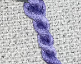 May include: A skein of purple cotton embroidery floss, labeled "Dyeing for Cross Stitch Hand Dyed Fabric and Floss Cotton"