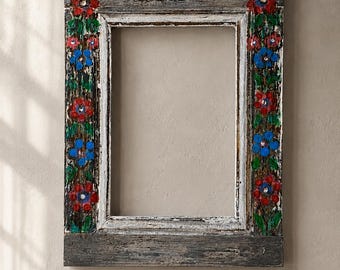 May include: A rectangular wooden picture frame with a weathered dark gray finish. The vertical sides are hand-painted with a floral pattern featuring alternating red and blue flowers with green leaves and stems against the distressed wood texture.