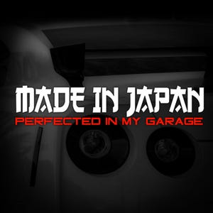May include: A graphic with the text "MADE IN JAPAN" in white, with "PERFECTED IN MY GARAGE" in red, set against a black backdrop. The image includes a car's rear, with taillights visible.