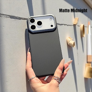 May include: Matte Midnight phone case with a carbon fiber texture. The case has a silver camera frame and a dark gray back. The text "Matte Midnight" is visible in the upper right corner.