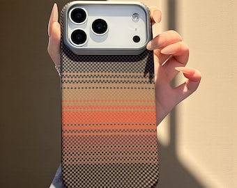 May include: A phone case with a geometric pattern in shades of brown, orange, and black. The case has a camera module with three lenses and a flash. The case is held by a person.