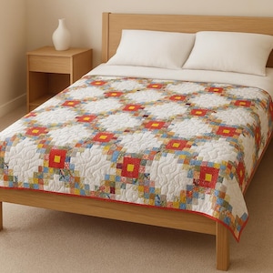 Puede incluir: Un edredón hecho a mano con un fondo blanco y un patrón repetido de cuadrados rojos y amarillos. El edredón tiene un borde rojo y un diseño de patchwork con varios colores.