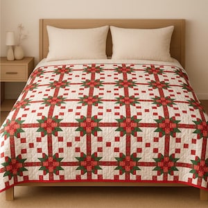 Puede incluir: Un edredón de color crema con un patrón repetitivo de formas geométricas rojas y verdes. El edredón está sobre una cama con almohadas de color crema y una cabecera de madera. El borde del edredón es rojo.