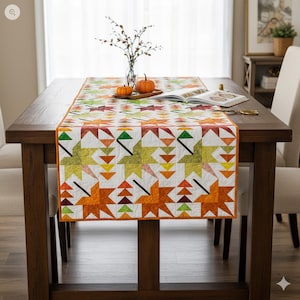 Peut inclure: Chemin de table aux couleurs automnales avec un motif géométrique en forme d'étoiles dans des tons orange, vert et jaune. Le chemin de table, d'environ 152 cm de long, est posé sur une table en bois foncé, décorée de citrouilles et d'un livre.
