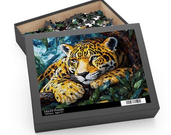 May include: A 500-piece jigsaw puzzle in a black box featuring a mosaic-style image of a yellow and black jaguar resting among green foliage. The box lid displays the text 16x20 Puzzle, 500 pcs, and Ages 9+, with a barcode visible in the corner.