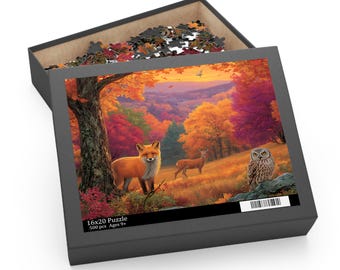 May include: A 500-piece jigsaw puzzle in a black box featuring an autumn forest scene with a fox, a deer, and an owl. The box lid displays the text 16x20 Puzzle, 500 pcs, and Ages 9+. The puzzle pieces are visible inside the open box container.