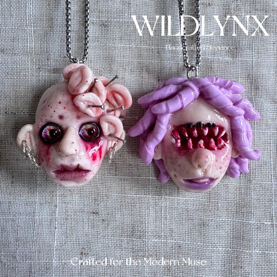 A hand-sculpted polymer clay doll pendant with a dark narrative baked right in — 'The Listener & The Whisperer' is wearable storytelling that nobody else will have.