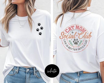 May include: White t-shirt with paw prints on the front and "Cat Mom Social Club Life is Better With a Cat" text on the back.