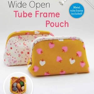 May include: Two fabric pouches with a metal tube frame. The pouch on the left has a white background with pink and white floral designs. The pouch on the right has a yellow background with pink strawberry designs. The text "Wide Open Tube Frame Pouch" is printed above the pouches. The text "Metal tube frame included!" is printed in a blue box.