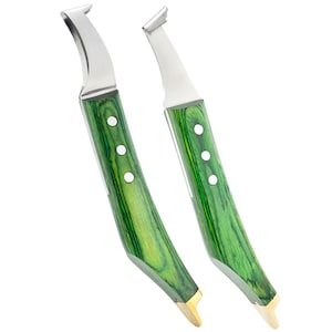May include: Two hoof knives with curved stainless steel blades and green wooden handles. The handles have a wood grain pattern and are accented with three silver rivets. The base of the handles have a gold-colored metal.