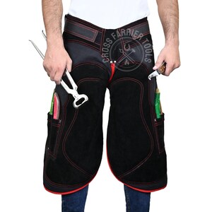 May include: Black leather blacksmith apron with red stitching and multiple pockets. The apron has a tool belt with a buckle and a logo that says "Cross Farrier Tools".