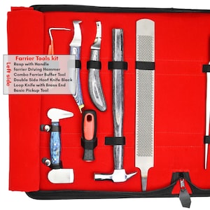 May include: A farrier tools kit displayed open, revealing various tools against a red interior. The kit includes a rasp with handle, a driving hammer, a buffer tool, hoof knives, and a pickup tool. The tools have wooden and metal components.