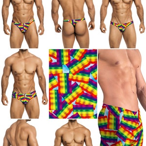 May include: A set of men's swimwear featuring a rainbow flag print. The swimwear includes a thong, a brief, and a pair of swim trunks.