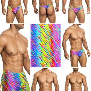 Op de afbeelding: Een collectie zwemkleding met een levendig, meerkleurig neon tijgerstreepmotief in tinten roze, geel, blauw en groen. De set bevat verschillende stijlen slips en shorts, die allemaal hetzelfde contrastrijke, abstracte patroon vertonen.