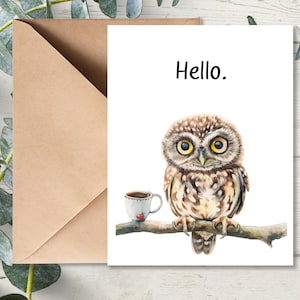 May include: A greeting card with the word "Hello." printed on it. A watercolor illustration of a brown owl perched on a branch with a small cup of coffee next to it.