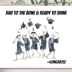May include: A graduation card with the text "RAD TO THE BONE & READY TO SHINE" and "-CONGRATS!". The card features a watercolor illustration of skeletons in graduation gowns and caps, celebrating.