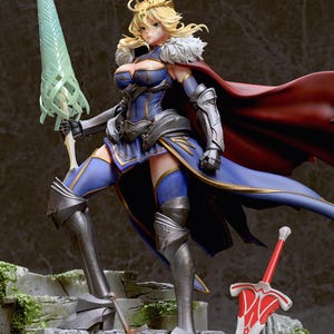 May include: A blue and gold-trimmed figure of a female warrior with blonde hair, wearing a red cape and holding a green spear. She is standing on a stone platform with a red sword lying on the ground beside her.