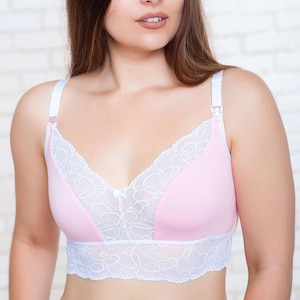 May include: A pink nursing bra with white lace trim and adjustable straps. The bra features a V-neck design and a delicate bow detail. The brand name "ZNANA" is visible in the top left corner.