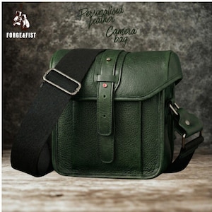 May include: A set of three ceramic mugs with a speckled, matte finish. Each mug features a different color: light blue, cream, and gray. The mugs have a simple, modern design with a rounded shape and a comfortable handle.