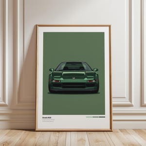 Peut inclure: Une impression d'art encadrée représentant une voiture de sport Honda NSX vert foncé centrée sur un fond vert uni. Le texte en bas indique Honda NSX, Engineered by Honda, Perfected by Senna, avec trois petits échantillons de couleur à droite.