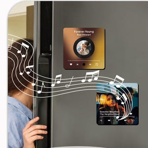 May include: Two square refrigerator magnets featuring music player interfaces. The top magnet displays 'Forever Young' by Rod Stewart with a circular photo. The bottom magnet shows 'Sweater Weather' by The Neighborhood with a photo of a person.