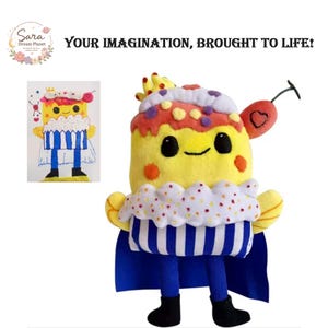 May include: A plush toy shaped like a yellow cupcake character with a smiling face, orange cheeks, and a blue striped base. It wears a blue cape, has yellow arms, black legs, and a red cherry on top. Includes a drawing of the same character.