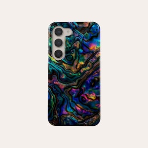 May include: A smartphone case with an iridescent abalone shell design. The case displays a swirling pattern of blues, greens, purples, and golds. The case has a camera module with three lenses. The design creates a unique and eye-catching aesthetic.