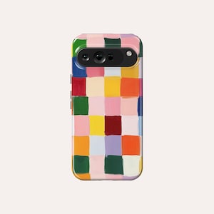 Puede incluir: Una funda de teléfono colorida con un patrón geométrico de cuadrados en tonos de rosa, amarillo, verde, rojo, naranja y azul.