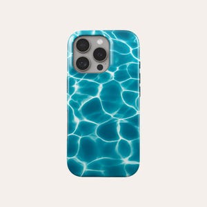 May include: A smartphone case featuring a vibrant blue water ripple design. The case has a glossy finish and a camera cutout with multiple lenses. The overall aesthetic is reminiscent of a sunny day at the pool or ocean.