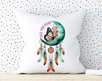 May include: White pillow with a teal blue crescent moon dreamcatcher with a butterfly and feathers. The text "Chase Your Dream" is written on the moon in purple.