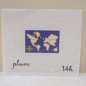 May include: A square white needlepoint canvas featuring a central rectangular design of a world map in yellow on a blue background with a compass rose. The text "plum" is printed in black on the lower left and "14h" is printed on the lower right.
